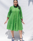 The model is wearing lichen green dress