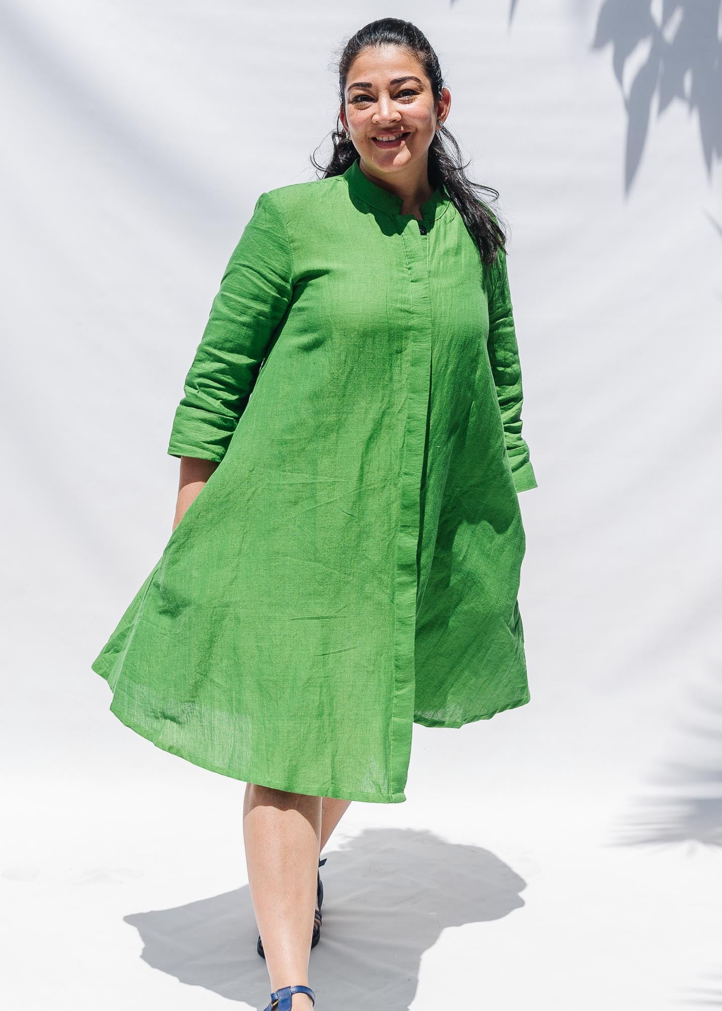 The model is wearing lichen green dress