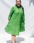 The model is wearing lichen green dress