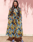 The model is wearing colorful geometric print dress