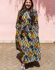 The model is wearing colorful geometric print dress