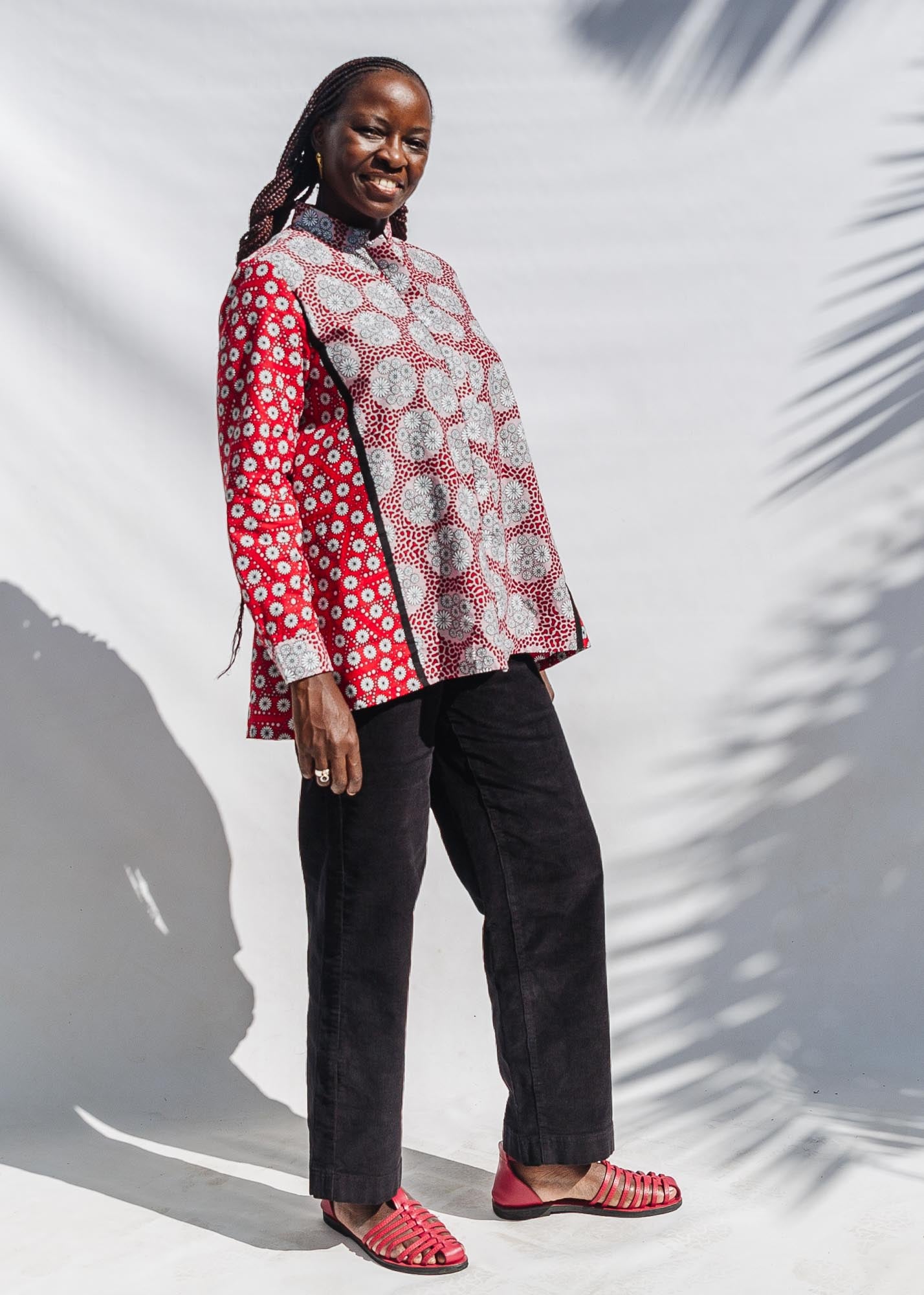 The model is wearing red, black, white print shirt