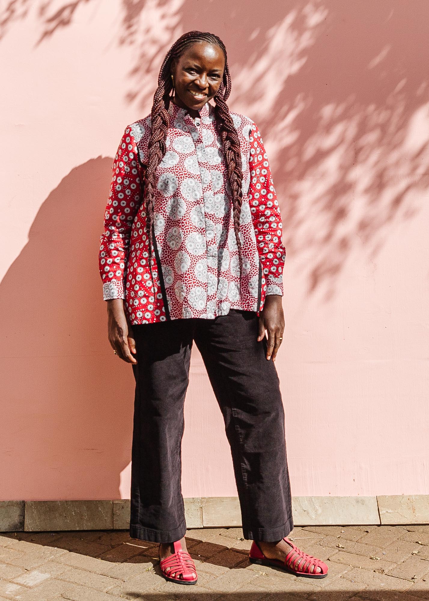 The model is wearing red, black, white print shirt