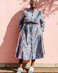 The model is wearing sky blue, blue, orange print dress