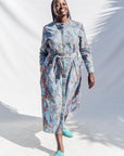 The model is wearing sky blue, blue, orange print dress