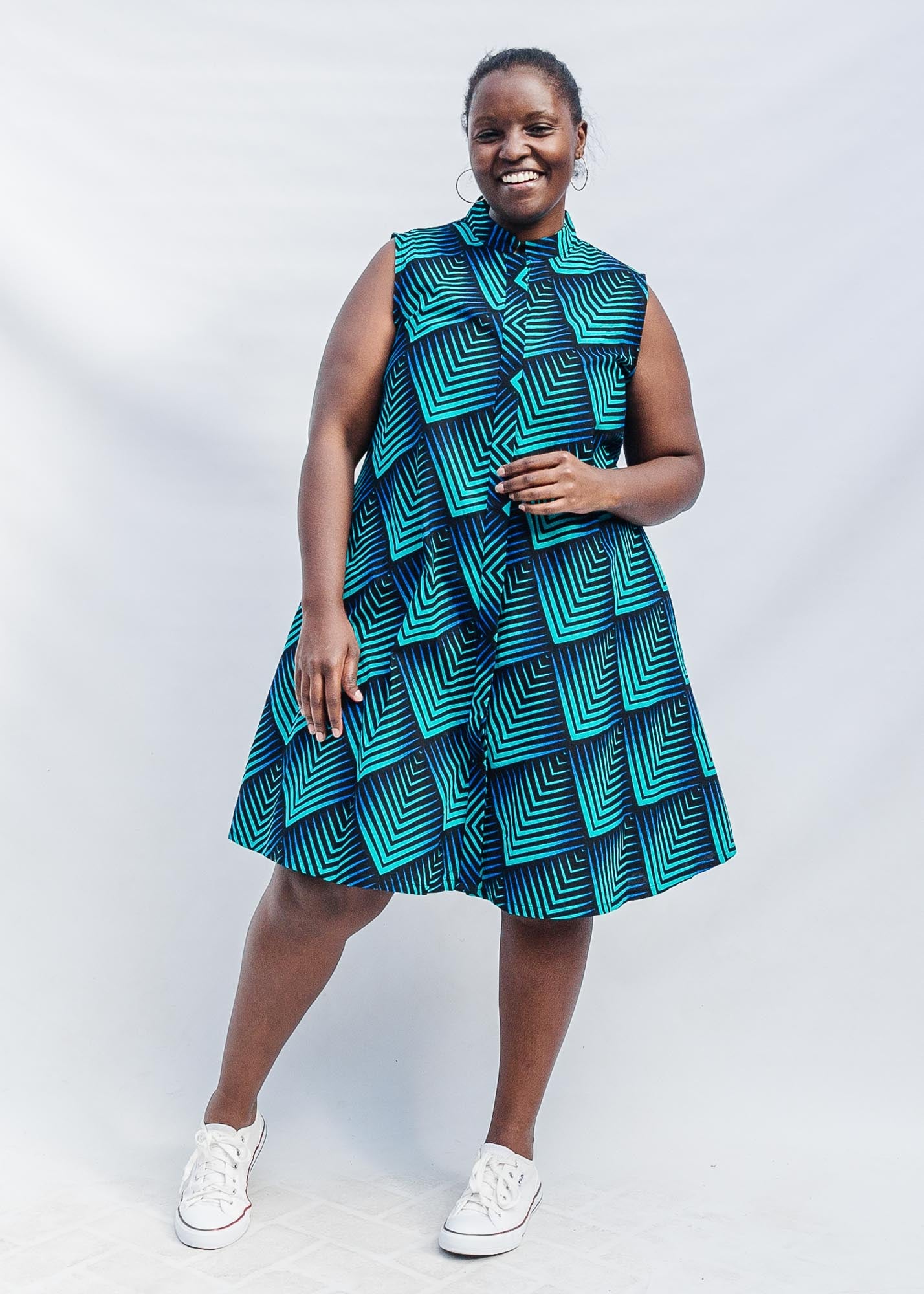 The model is wearing black, blue and aqua print dress