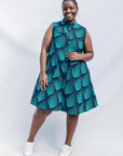 The model is wearing black, blue and aqua print dress