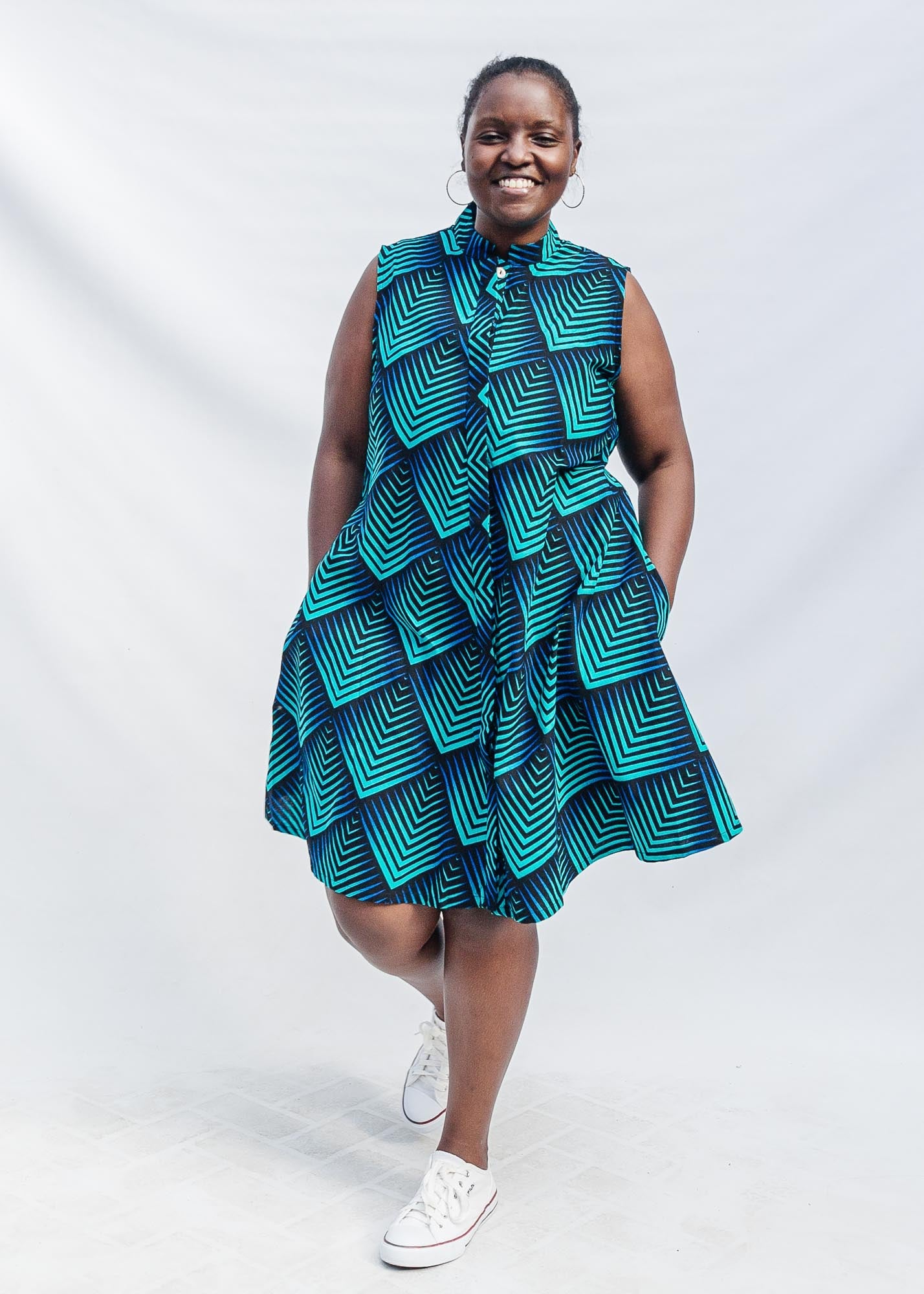 The model is wearing black, blue and aqua print dress