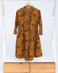 Display of caramel dress with blue and black small floral print.