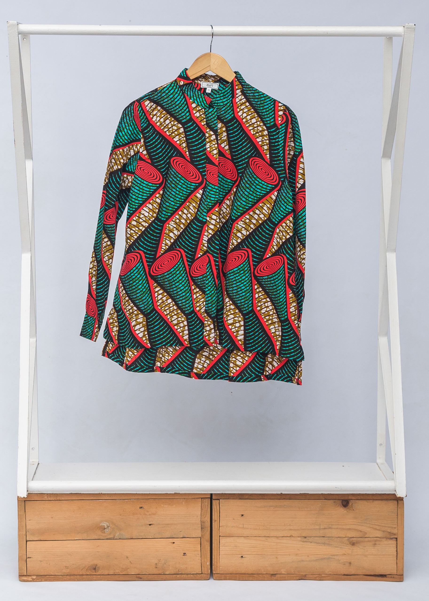 Display of green, red, black and brown scroll print long sleeve blouse.