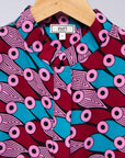 Display of pink, red, blue and black tube print long sleeve blouse.