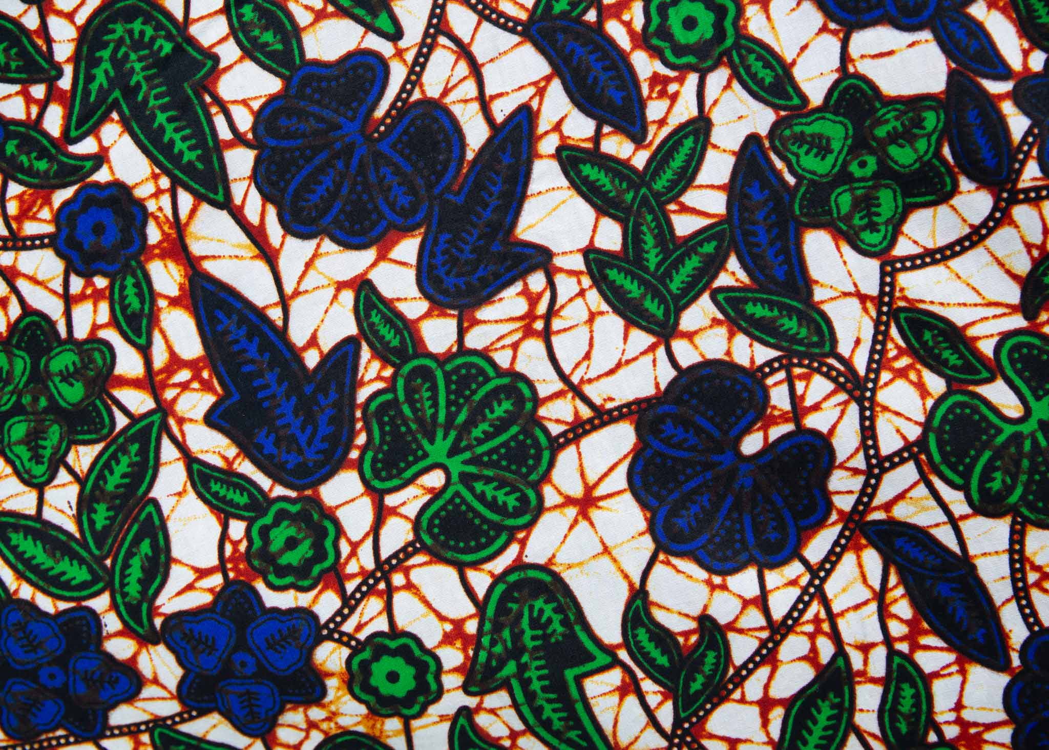 Close up Display of brown dress with blue and green vines, fabric.