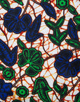 Close up Display of brown dress with blue and green vines, fabric.