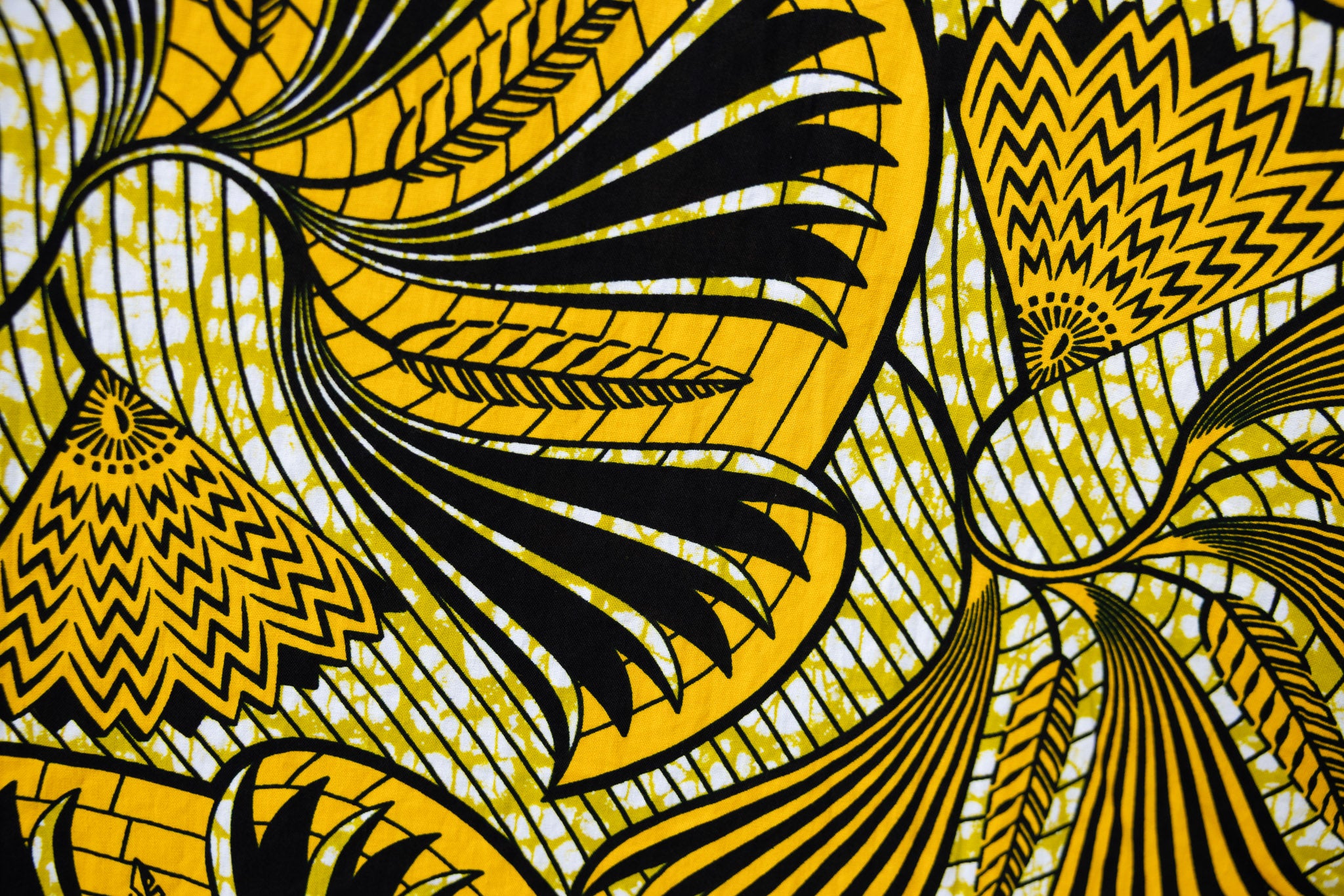 Close up of yellow and black sleeveless maxi dress.