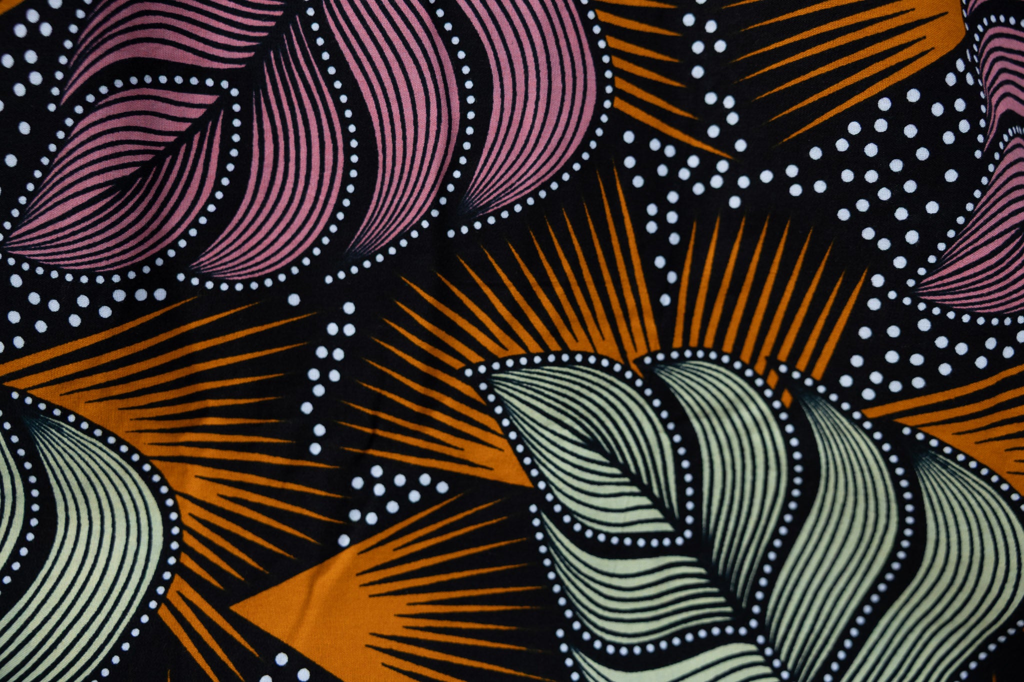 Close up display of orange and pink long sleeved blouse.