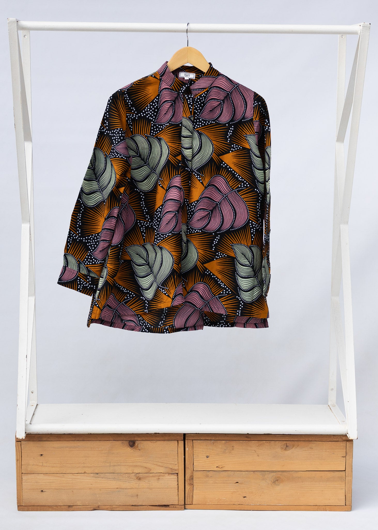 Display of orange and pink long sleeved blouse.