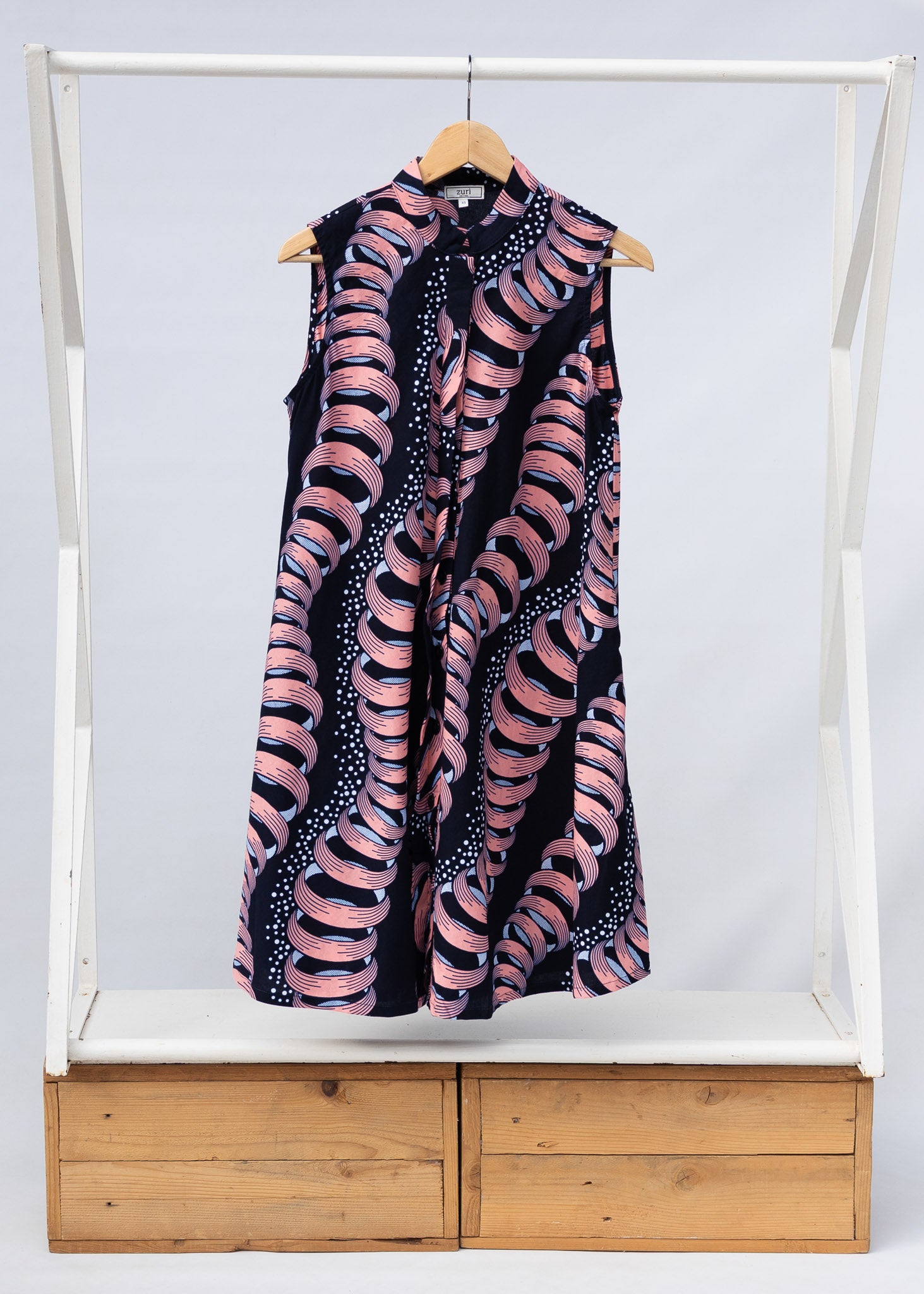 Display of black and pink sleeveless print dress.