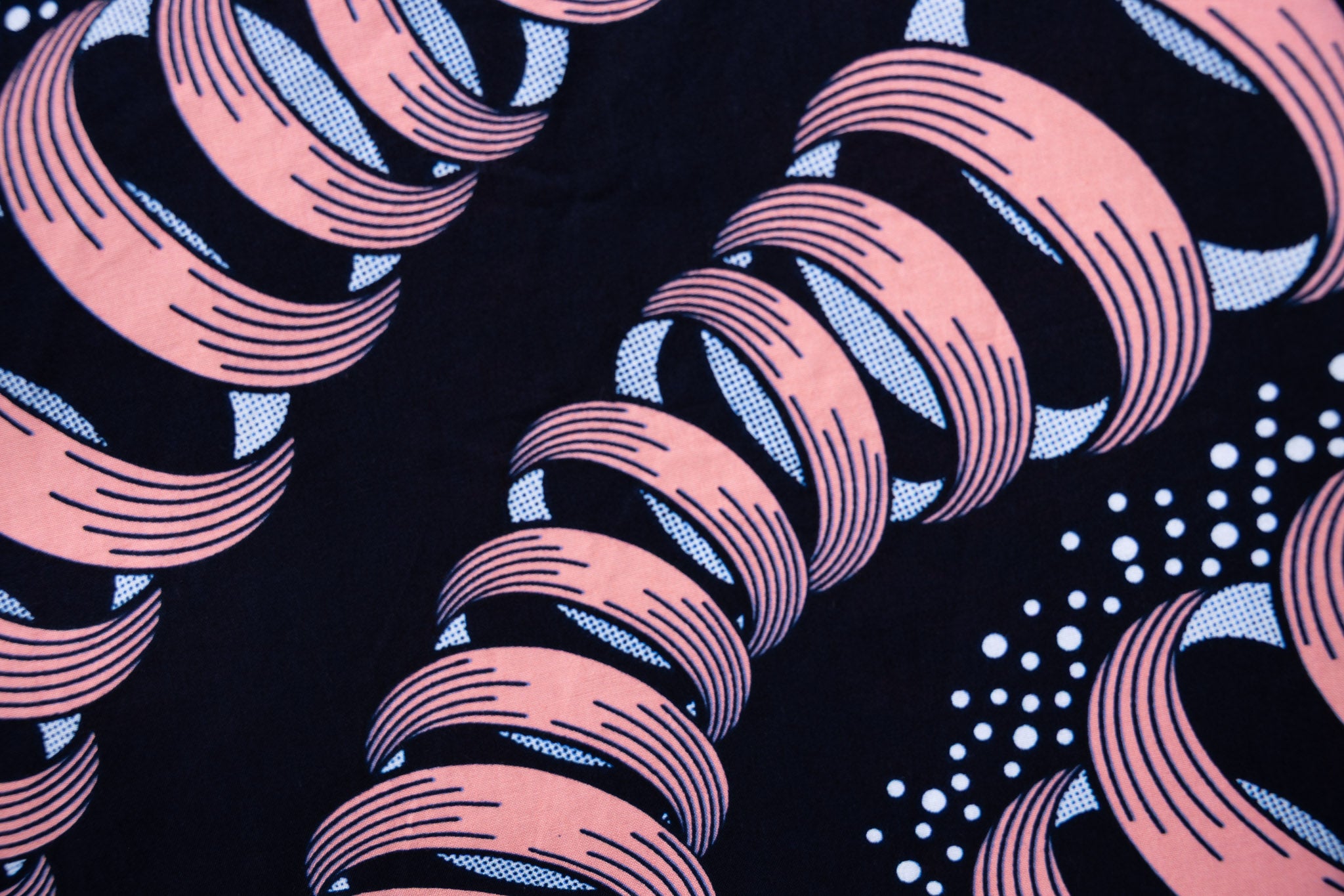Close up display of black and pink sleeveless print dress.