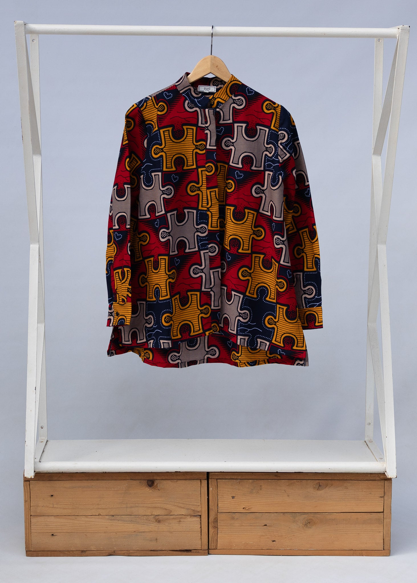 Display of multicolored puzzle print shirt.