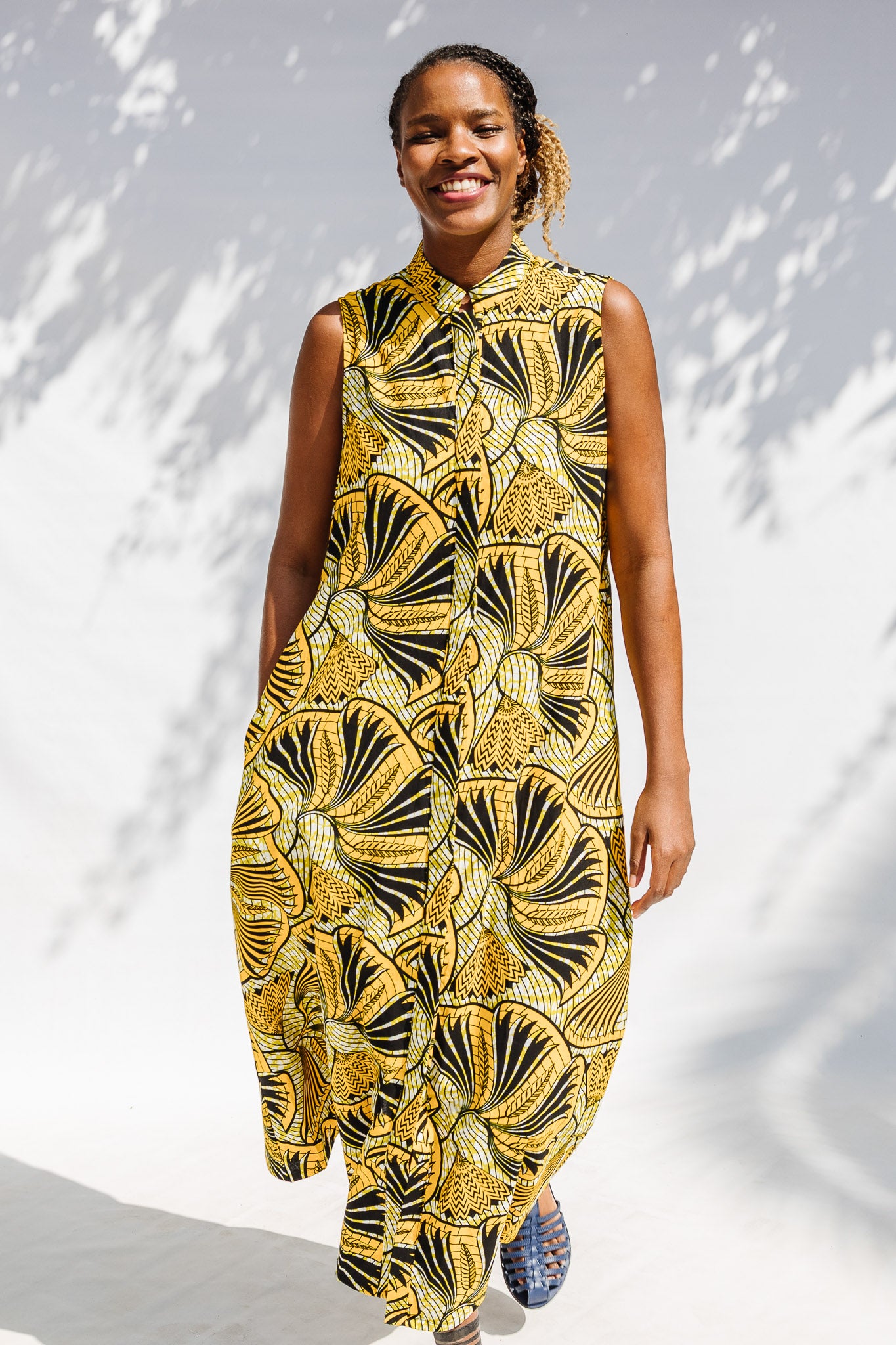 Model wearing yellow and black sleeveless maxi dress.