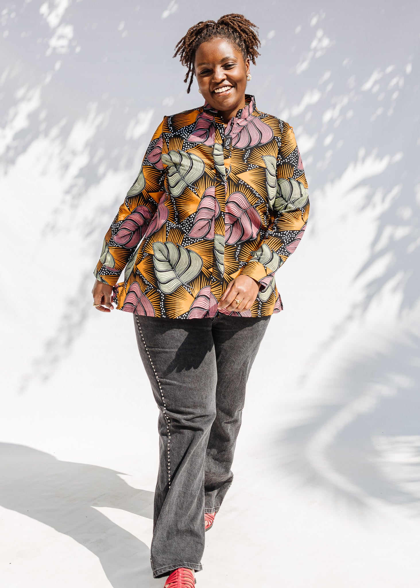 Model wearing pink and orange long sleeved blouse.