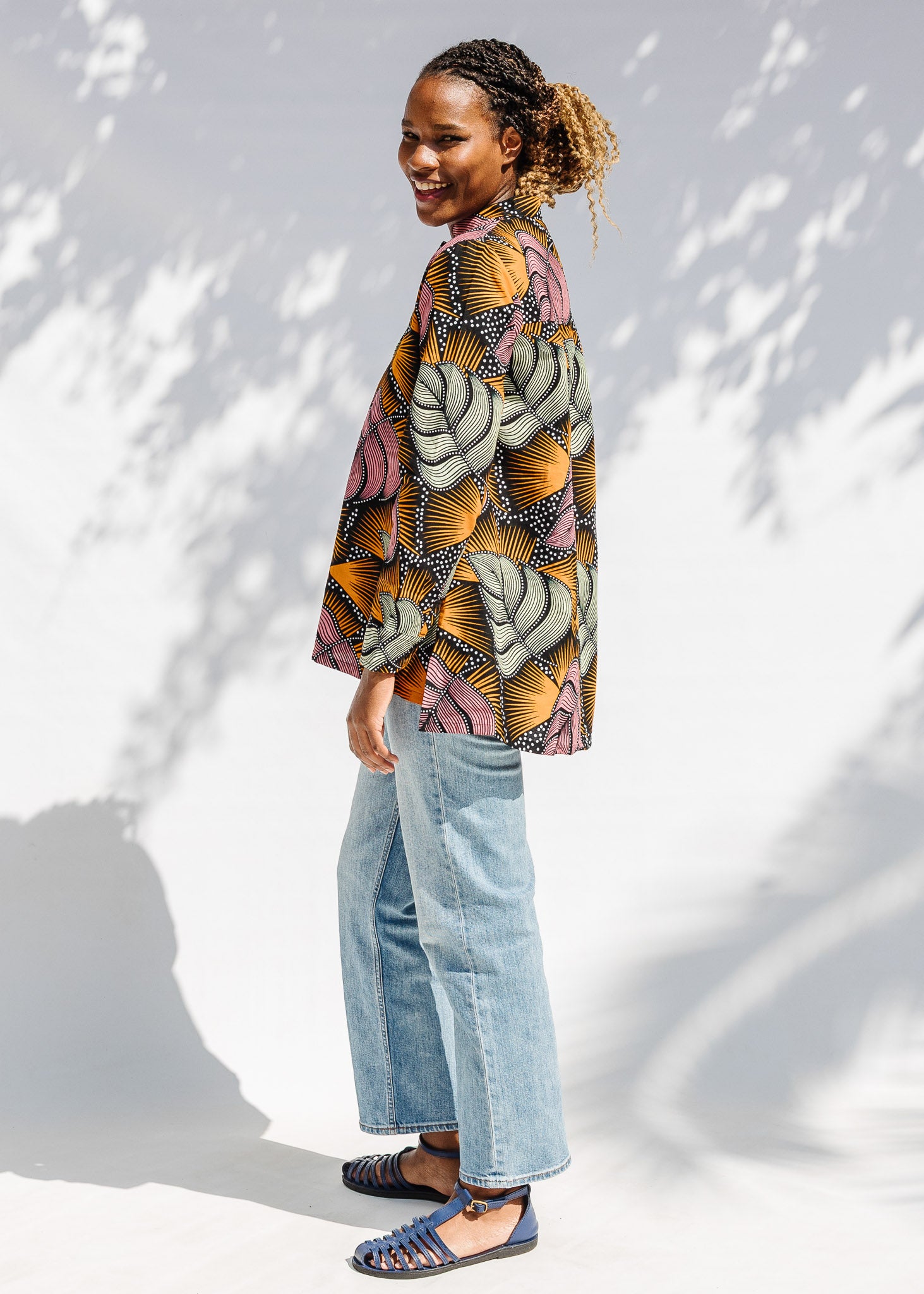 Model wearing pink and orange long sleeved blouse.
