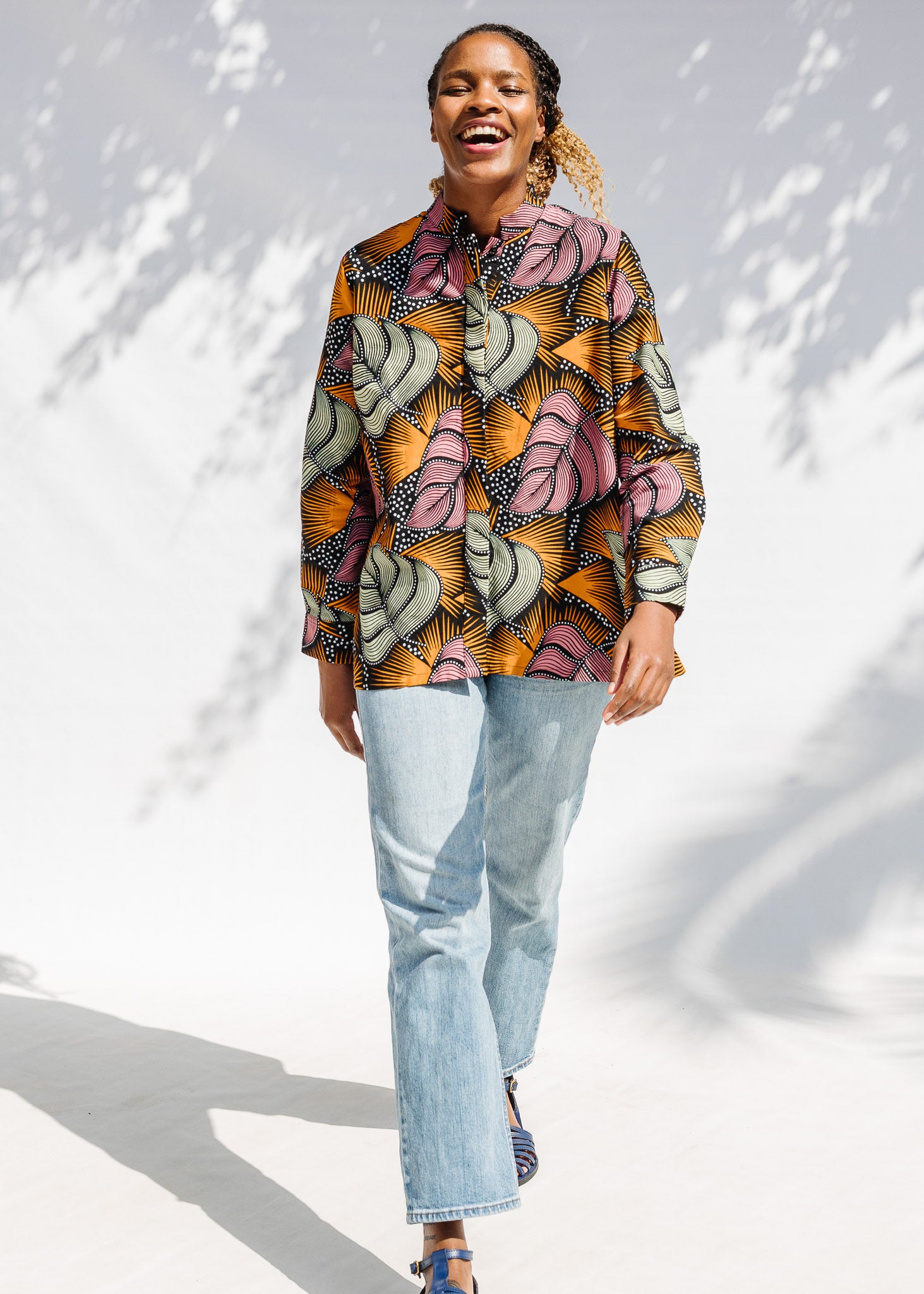 Model wearing pink and orange long sleeved blouse.