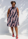 Model wearing black and pink sleeveless print dress.