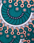 Close up display of teal, white, black and peach dress with gears