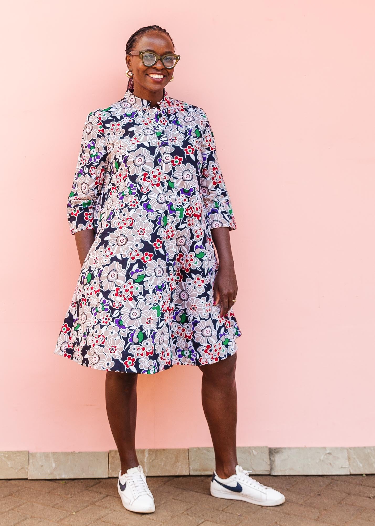 The model is wearing multi-colored floral print 