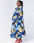 Model wearing blue, black, orange, yellow, orange and white geometric print shirt and culotte.