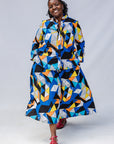 Model wearing blue, black, orange, yellow, orange and white geometric print shirt and culotte.