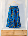 Display of blue pants with beige fish print.