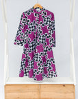 Display of purple dress with black and white puzzle print.
