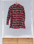 Display of a red, brown and black scroll printed long sleeve blouse.