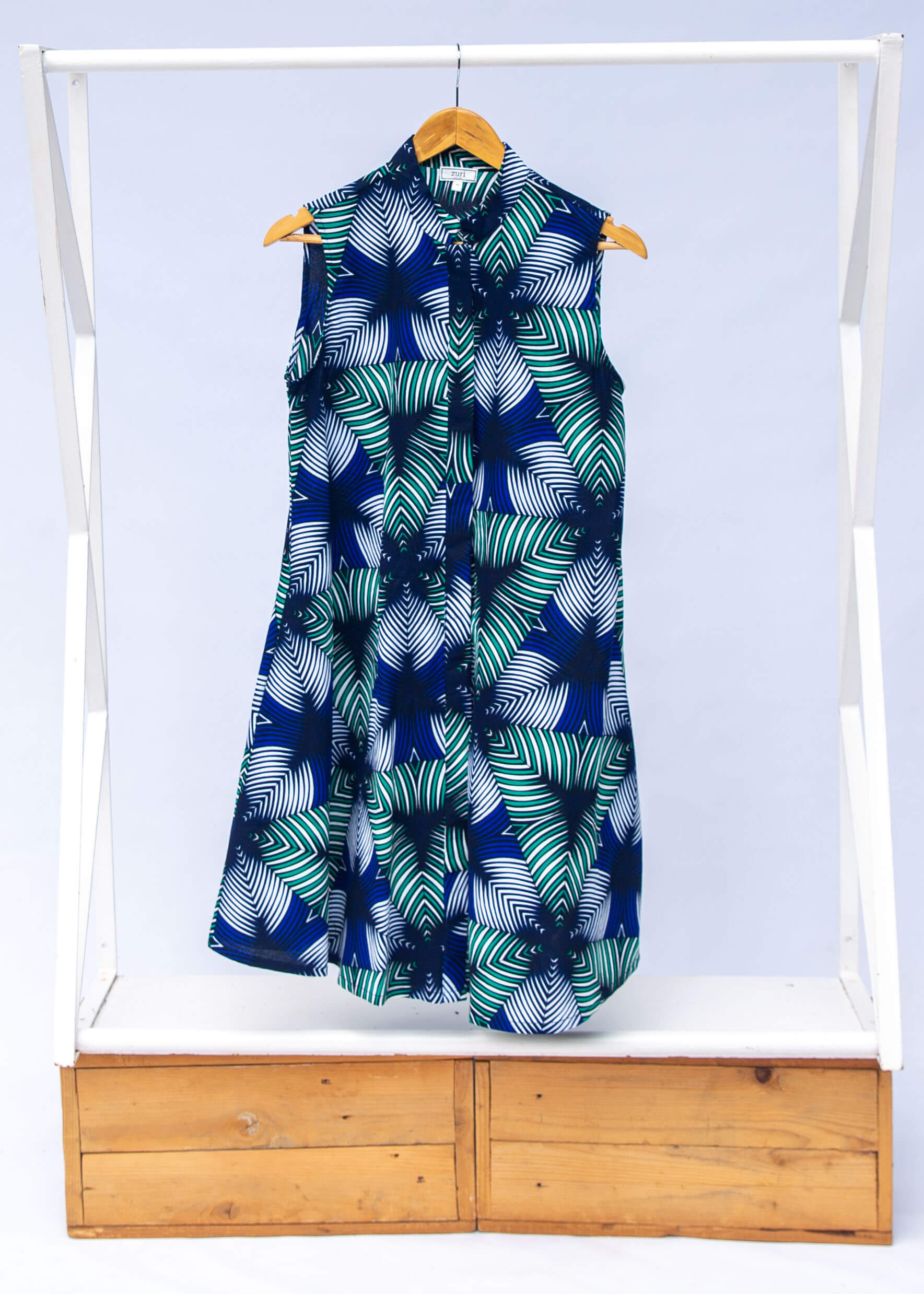 Display of blue, white, and green, geometric print dress.