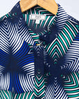 Display of blue, white, and green, geometric print dress.