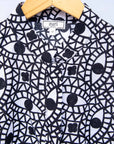 Display of black and white eye print sleeveless shirt.
