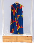 Display of navy sleeveless dress with red and yellow print fish print.