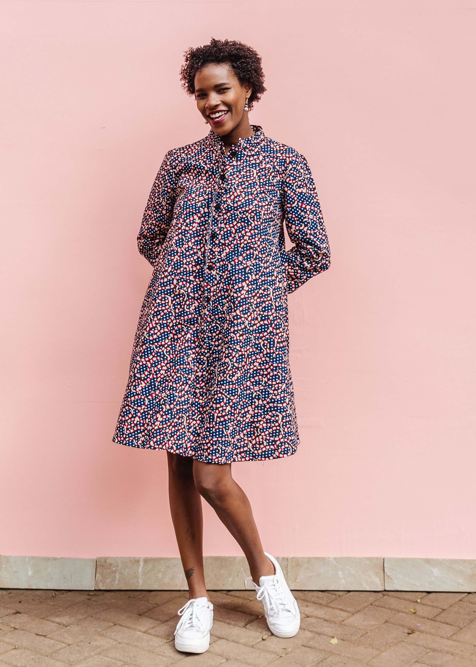  Model wearing blue and red ribbon print dress.