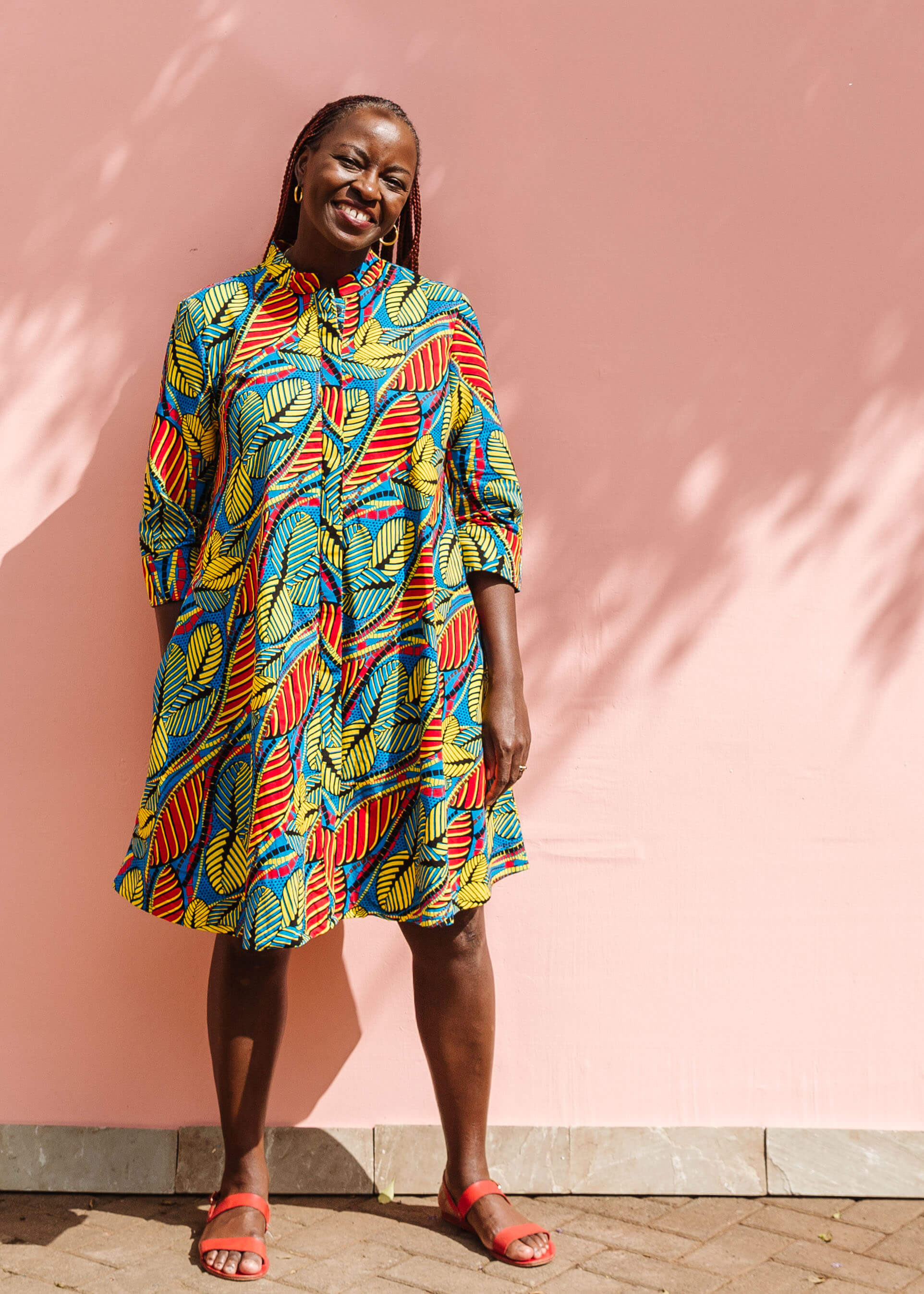 Model wearing colorful rainbow leaves print dress.