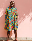 Model wearing colorful rainbow leaves print dress.