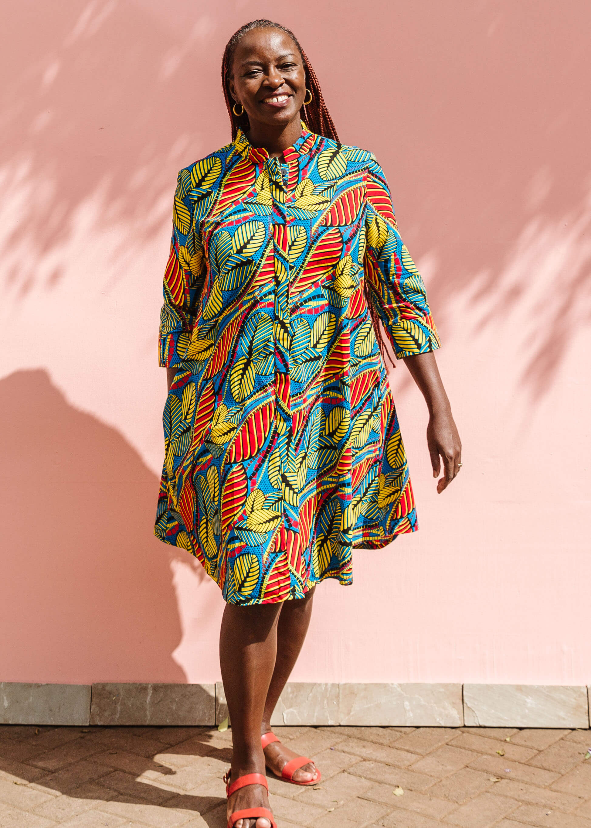 Model wearing colorful rainbow leaves print dress.