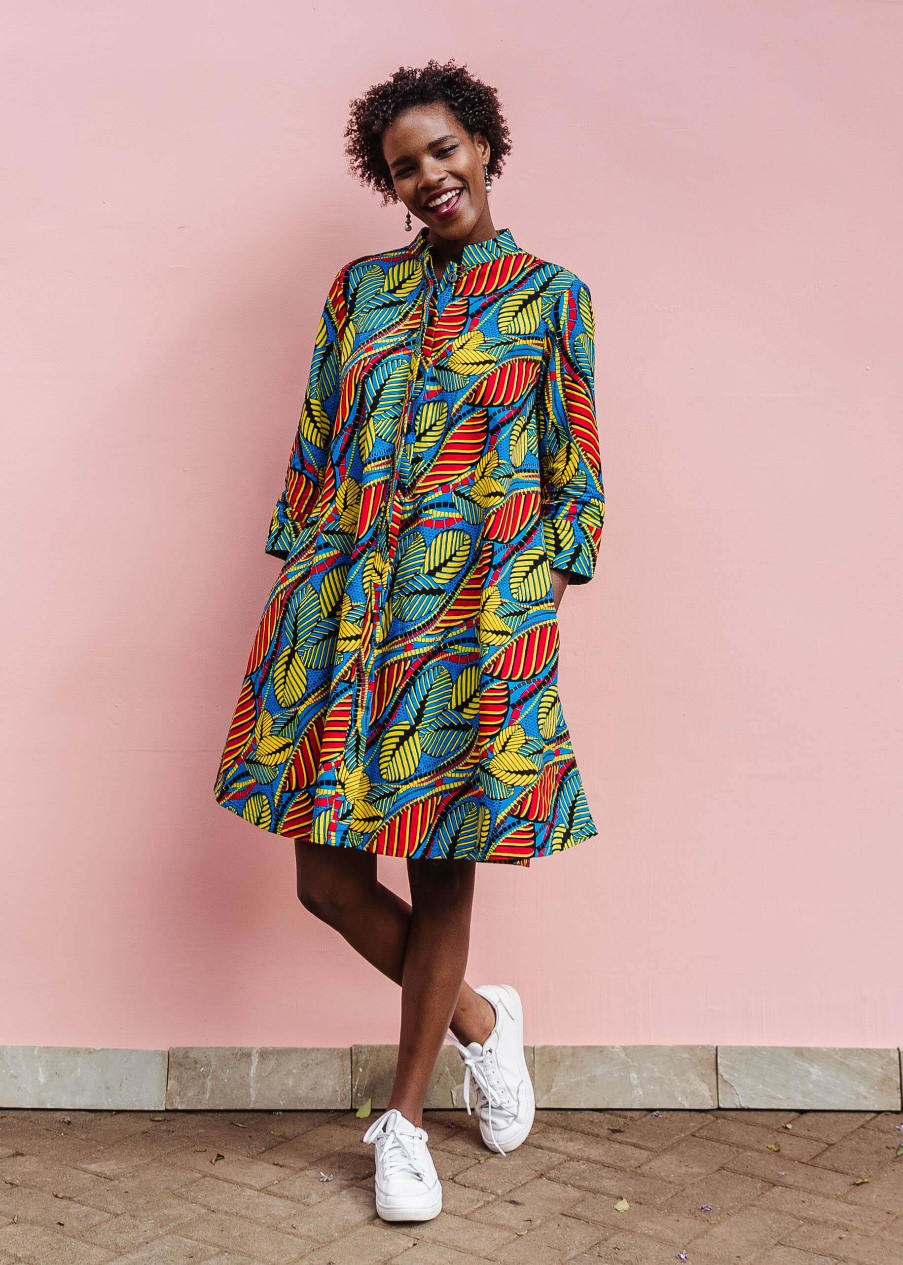 Model wearing colorful rainbow leaves print dress.