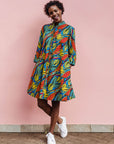 Model wearing colorful rainbow leaves print dress.