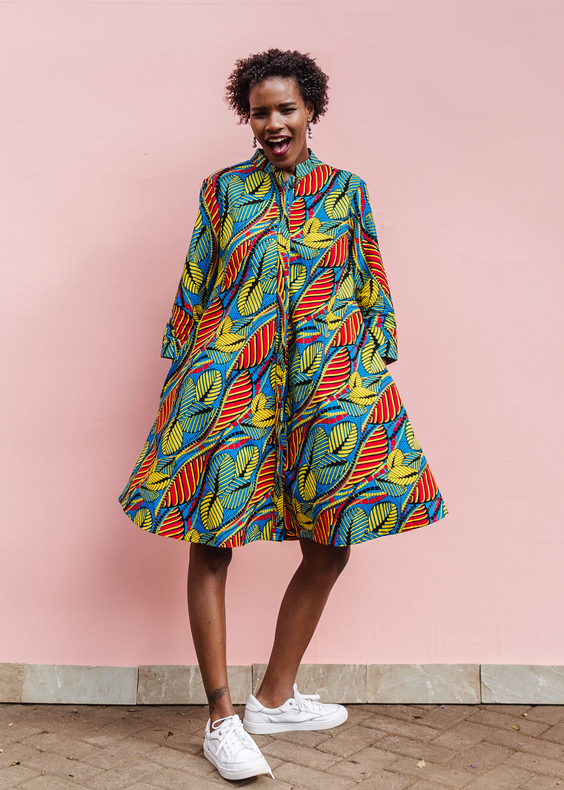 Model wearing colorful rainbow leaves print dress.