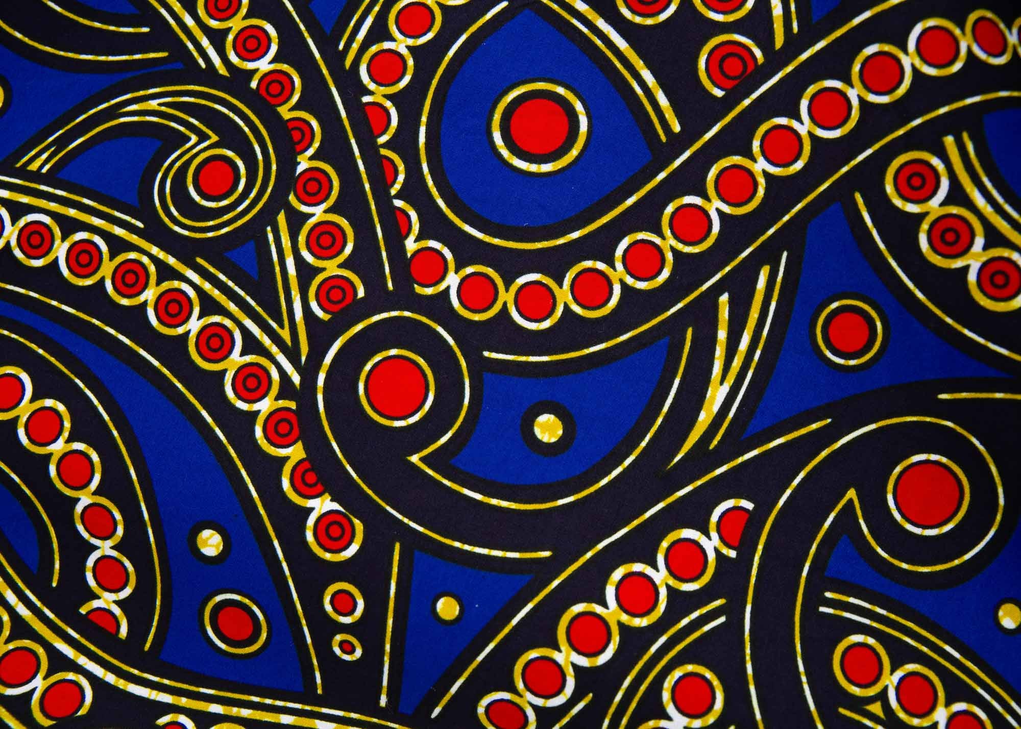 Close up display blue, red, black, yellow and white ornamental print, fabric