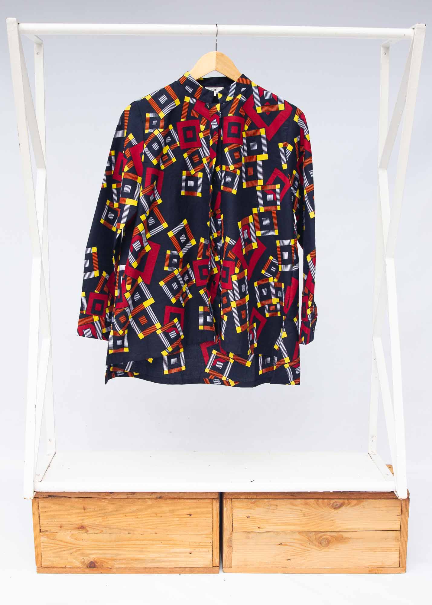 The display of navy shirt with red, orange, yellow and white geometric print 