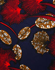 Close up of navy dress with red, white and orange floral print, fabric
