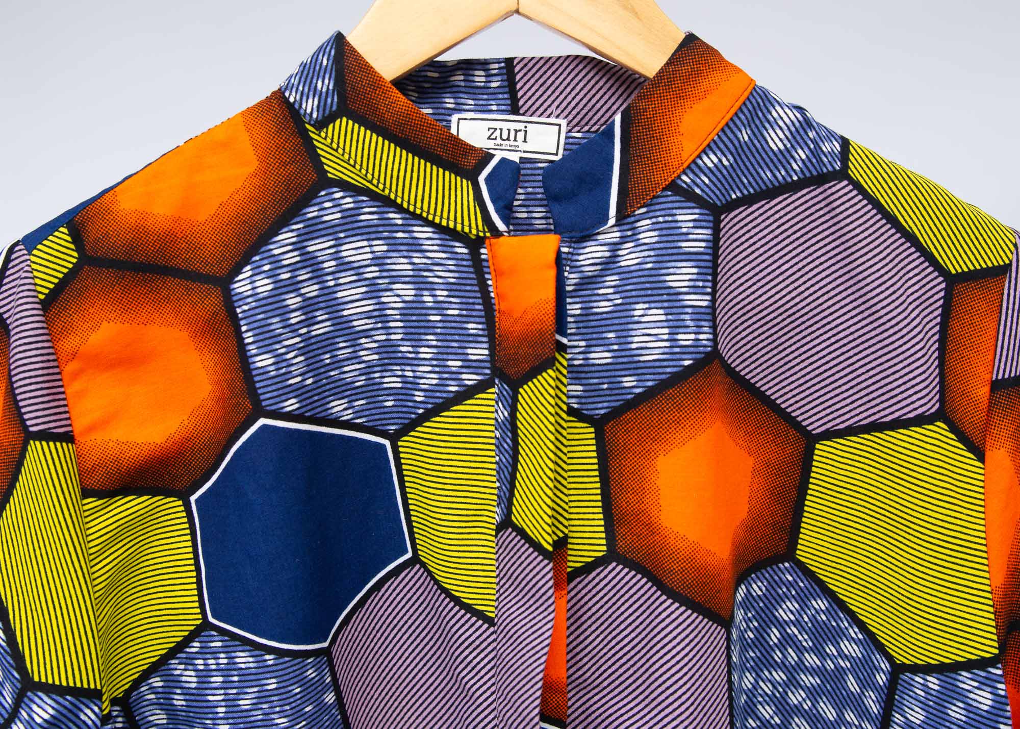 Display of multicolored long sleeved shirt with geometric print 